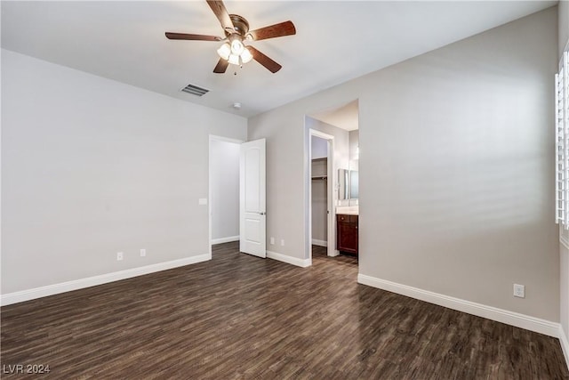 8351 Agave Bloom St, Las Vegas, NV 89131 - unfurnished bedroom with dark wood-style floors, baseboards, ceiling fan, and ensuite bathroom