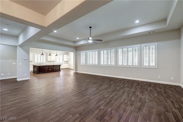 8351 Agave Bloom St, Las Vegas, NV 89131 - unfurnished living room featuring ceiling fan, dark wood-style flooring, baseboards, a tray ceiling, and recessed lighting