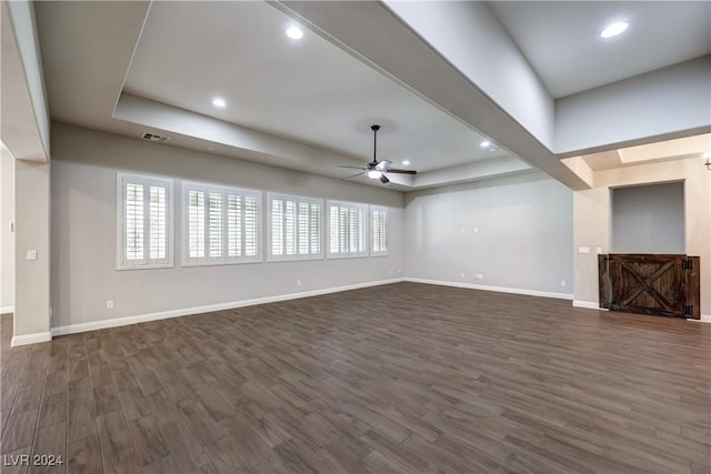 8351 Agave Bloom St, Las Vegas, NV 89131 - unfurnished living room featuring ceiling fan, dark wood-type flooring, baseboards, a tray ceiling, and recessed lighting