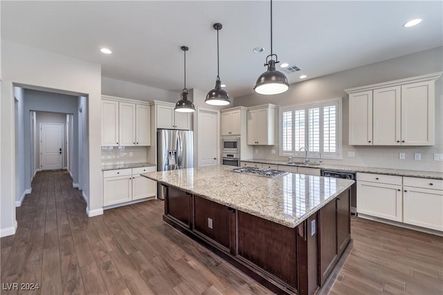 8351 Agave Bloom St, Las Vegas, NV 89131 - kitchen featuring appliances with stainless steel finishes, a kitchen island, white cabinets, light stone counters, and recessed lighting