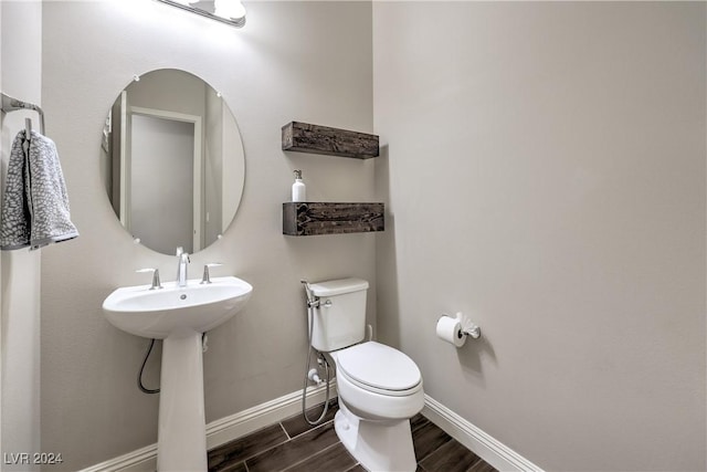 8351 Agave Bloom St, Las Vegas, NV 89131 - half bath with wood finished floors, toilet, baseboards, and a sink