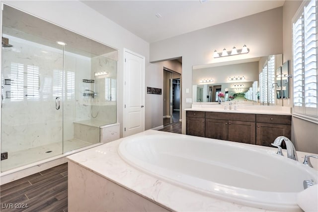 8351 Agave Bloom St, Las Vegas, NV 89131 - bathroom featuring a garden tub, a marble finish shower, healthy amount of natural light, and vanity