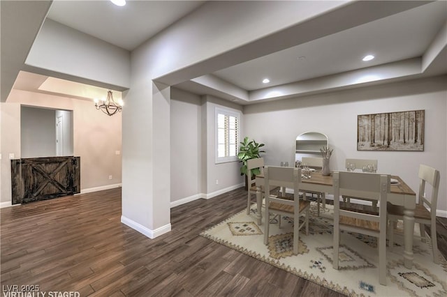 8351 Agave Bloom St, Las Vegas, NV 89131 - dining area featuring a tray ceiling, baseboards, wood finished floors, arched walkways, and a chandelier