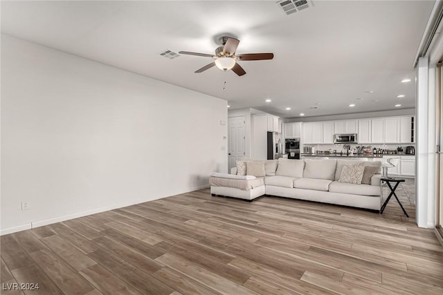 unfurnished living room with light hardwood / wood-style floors and ceiling fan