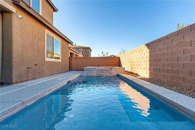 view of swimming pool with pool water feature