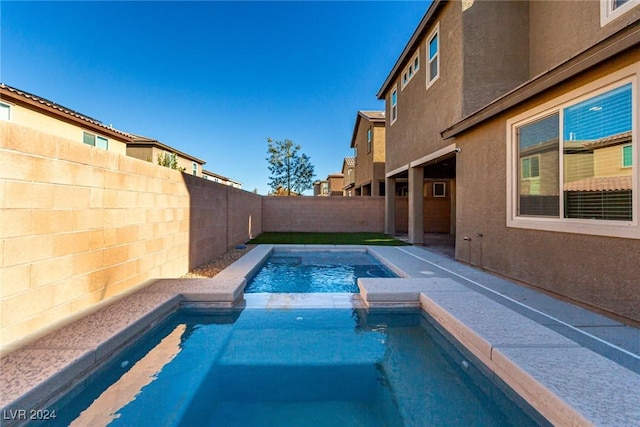 view of swimming pool with an in ground hot tub