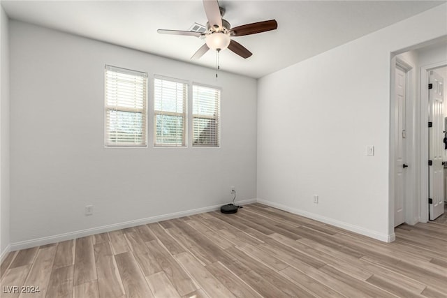 spare room with light hardwood / wood-style floors and ceiling fan