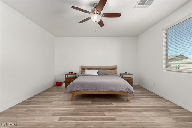 bedroom with ceiling fan and light wood-type flooring