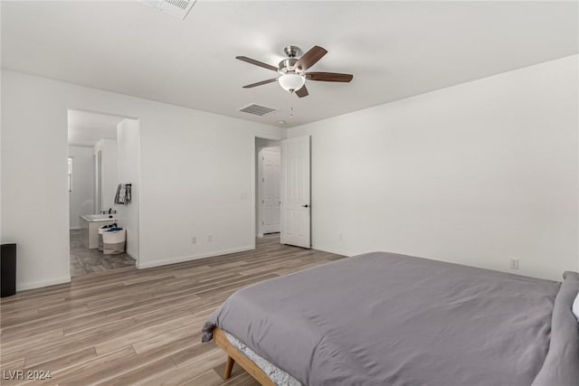 bedroom featuring ceiling fan, connected bathroom, and light wood-type flooring