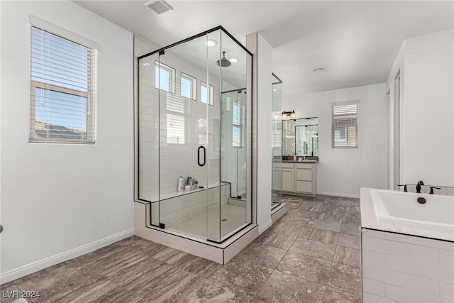 bathroom with an enclosed shower and vanity