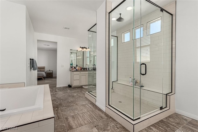 bathroom featuring independent shower and bath and vanity