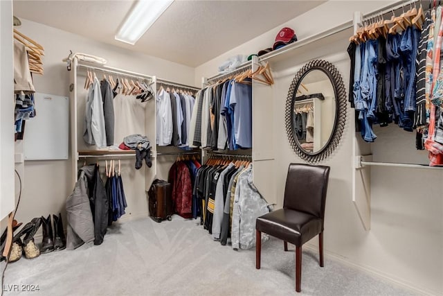 walk in closet featuring carpet