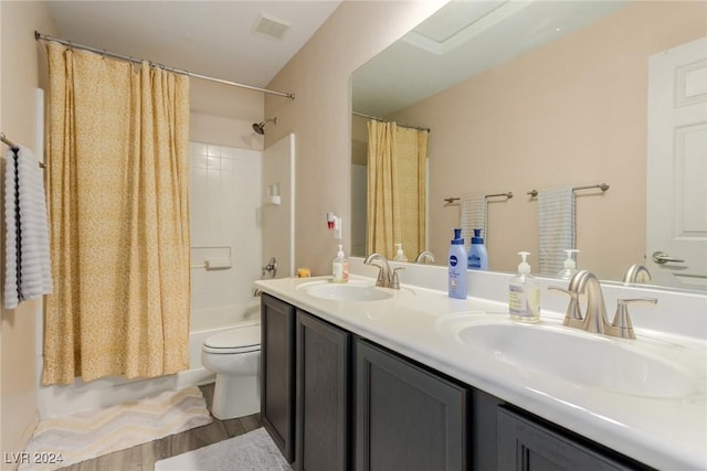 full bathroom with hardwood / wood-style floors, vanity, toilet, and shower / bathtub combination with curtain