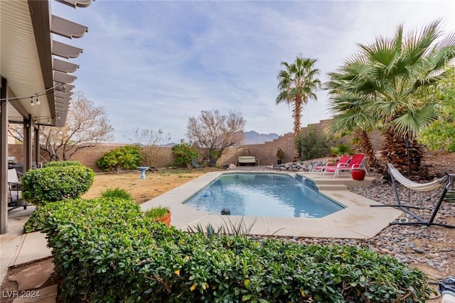 view of pool featuring a patio area and a mountain view