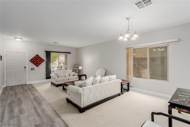 living room featuring light hardwood / wood-style floors and a chandelier