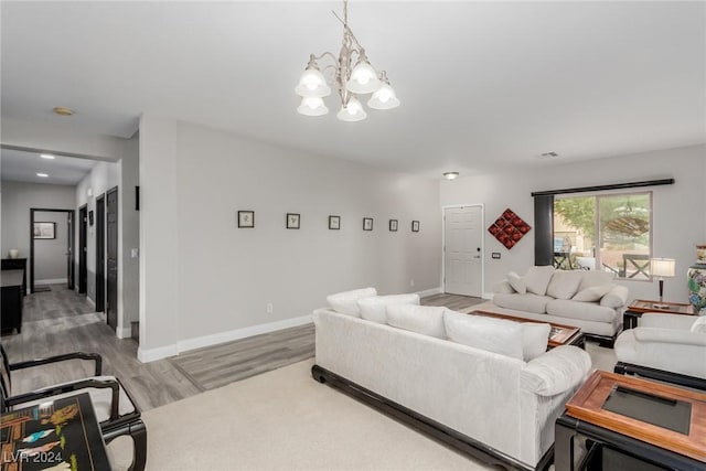 living room with a chandelier and wood-type flooring