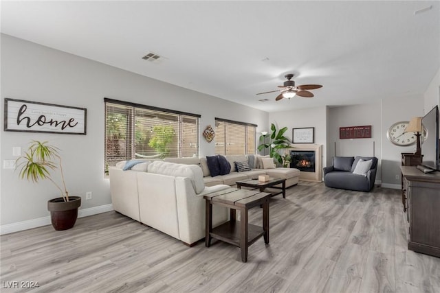 living room featuring ceiling fan and light wood-type flooring