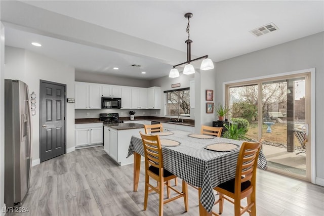 dining area featuring sink and light hardwood / wood-style flooring