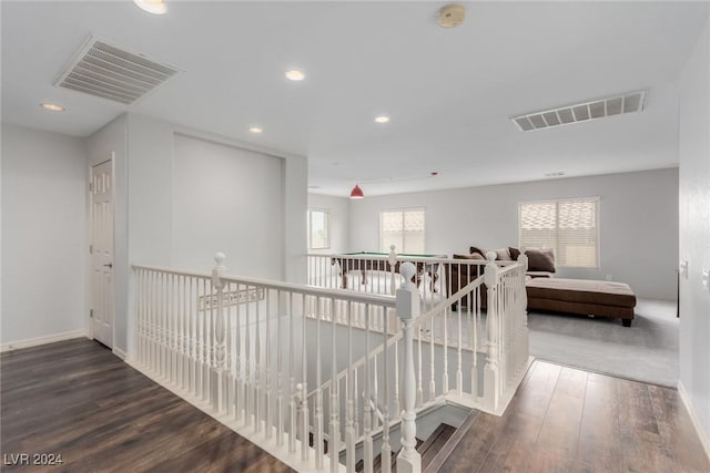 corridor with hardwood / wood-style floors