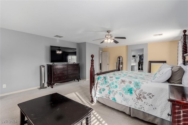 bedroom with ceiling fan, a closet, and light colored carpet