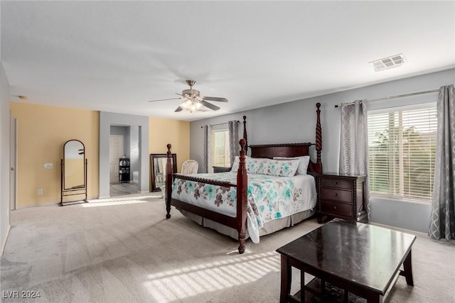 bedroom featuring ceiling fan and light carpet