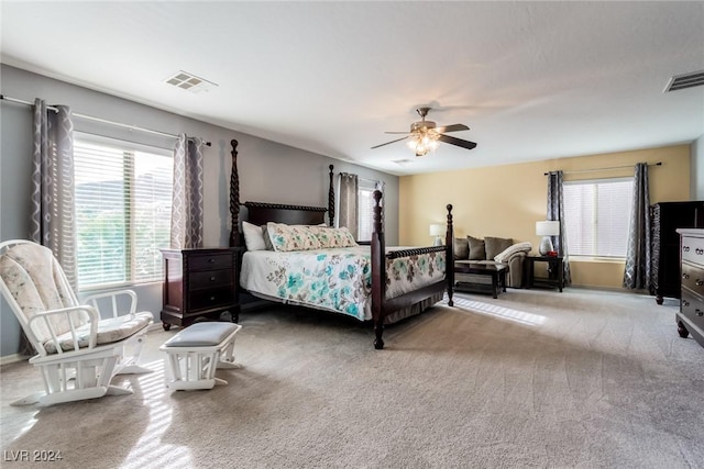 bedroom with carpet flooring, multiple windows, and ceiling fan