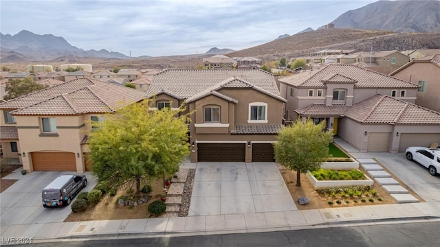 view of front of property featuring a mountain view and a garage