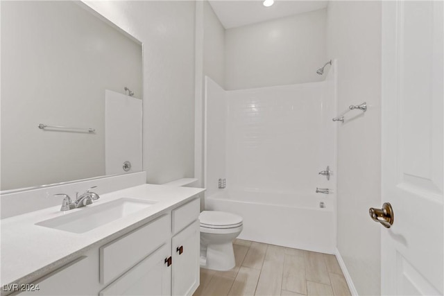 full bathroom featuring bathing tub / shower combination, vanity, and toilet