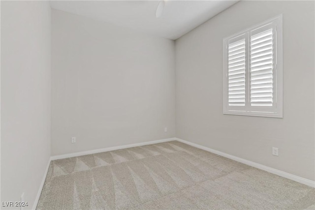 empty room featuring light carpet