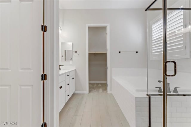 bathroom featuring separate shower and tub and vanity