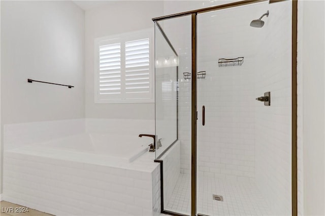 bathroom with shower with separate bathtub