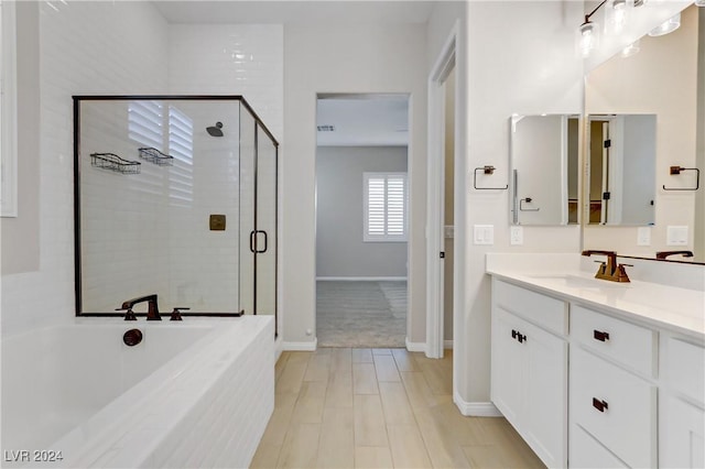 bathroom with vanity and independent shower and bath