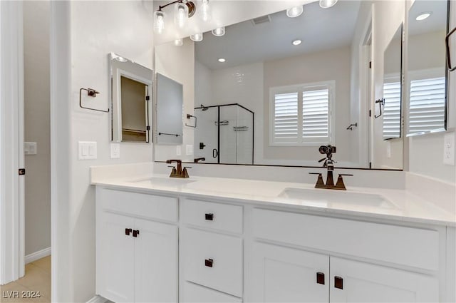 bathroom with tile patterned floors, vanity, and walk in shower