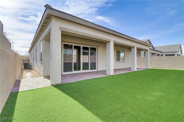 back of property featuring a yard, a patio area, and central air condition unit