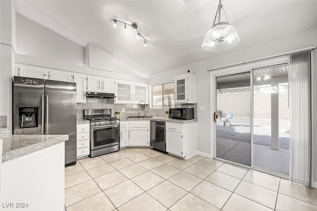 kitchen with a sink, tasteful backsplash, appliances with stainless steel finishes, and vaulted ceiling