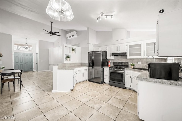 kitchen featuring under cabinet range hood, stainless steel range with gas stovetop, fridge with ice dispenser, light tile patterned floors, and a peninsula