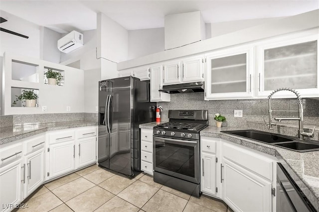 kitchen with stainless steel range with gas cooktop, under cabinet range hood, dishwasher, fridge with ice dispenser, and a sink