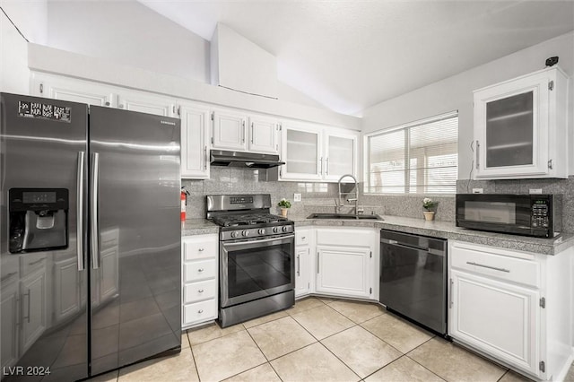 kitchen featuring under cabinet range hood, stainless steel appliances, lofted ceiling, and a sink