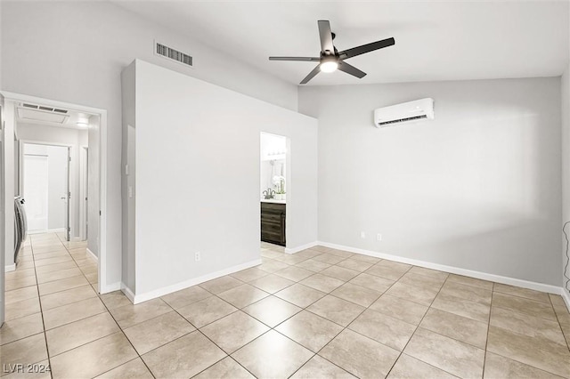 spare room featuring visible vents, ceiling fan, an AC wall unit, lofted ceiling, and light tile patterned flooring