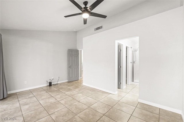 spare room featuring light tile patterned floors, visible vents, baseboards, and a ceiling fan