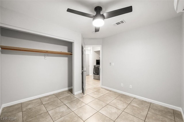 unfurnished bedroom featuring washer / clothes dryer, baseboards, visible vents, and a closet