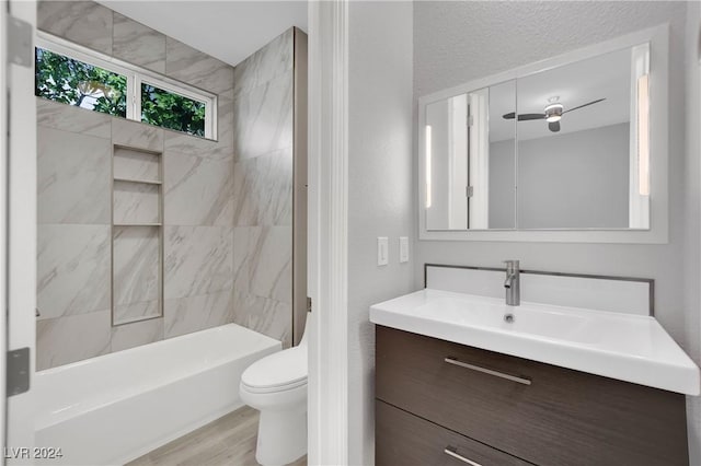 full bathroom featuring hardwood / wood-style flooring, vanity, toilet, and tiled shower / bath combo