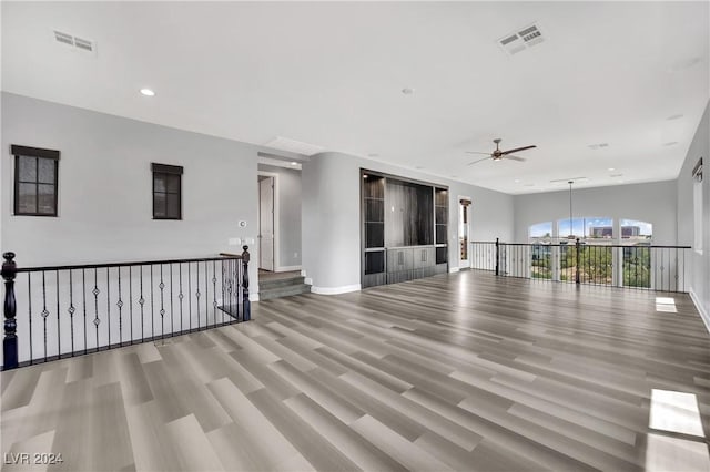 unfurnished room with ceiling fan and light wood-type flooring