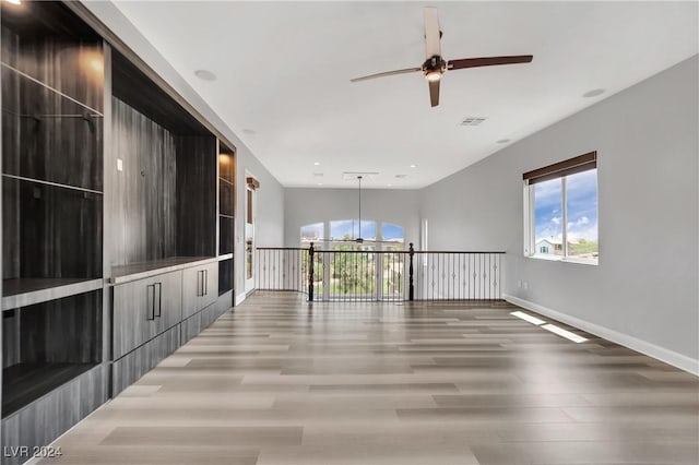 empty room with wood-type flooring and ceiling fan