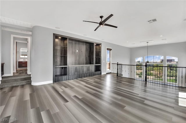 empty room with ceiling fan and hardwood / wood-style floors