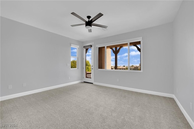 empty room featuring light colored carpet and ceiling fan