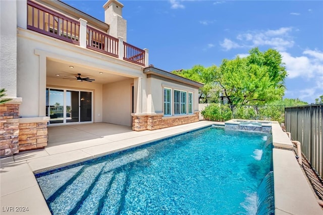 view of swimming pool with ceiling fan, a patio area, and an in ground hot tub