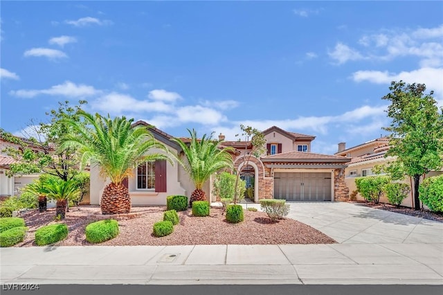 mediterranean / spanish-style house with a garage