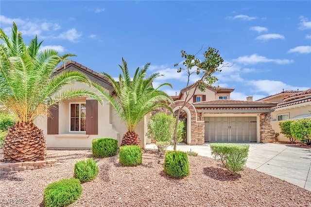 mediterranean / spanish-style home with a garage