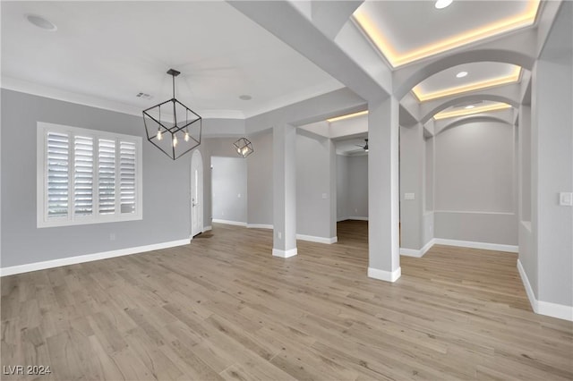 interior space featuring light hardwood / wood-style floors and ceiling fan with notable chandelier